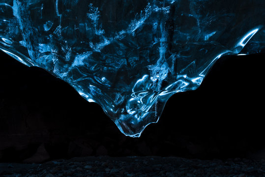 Silhouette of rocks in dark ice cave, iceland