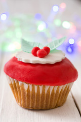 Christmas cupcakes and Christmas decoration
on white wood
