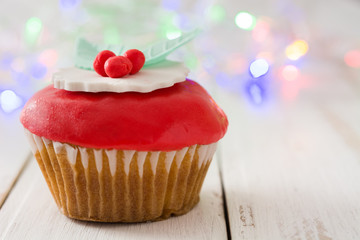 Christmas cupcakes and Christmas decoration
on white wood
