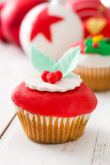 Christmas cupcakes and Christmas decoration
on white wood
