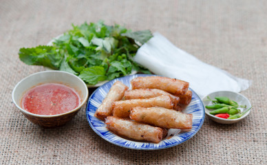 Fried spring rolls with paper rice and fresh vegetables