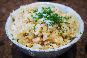 garlic fried rice with vegetables on top