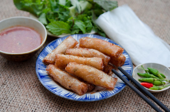 Fried spring rolls with paper rice and fresh vegetables