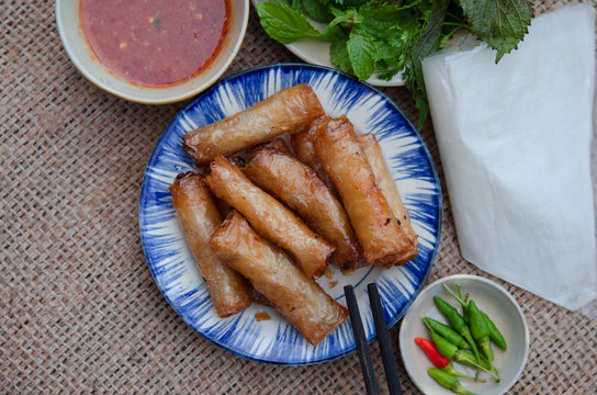 Fried spring rolls with paper rice and fresh vegetables