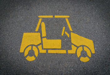 Yellow car sign on lanes asphalt road.