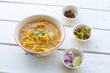 Curried Noodle Soup (Khao soi) on wood table