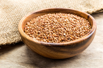 Bowl with Buckwheat on a wooden background