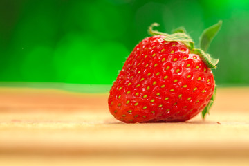 One berry fresh strawberries on a blurred background