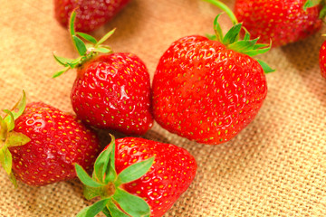 few berries with fresh strawberries on a fabric