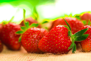 few berries with fresh strawberries on a fabric