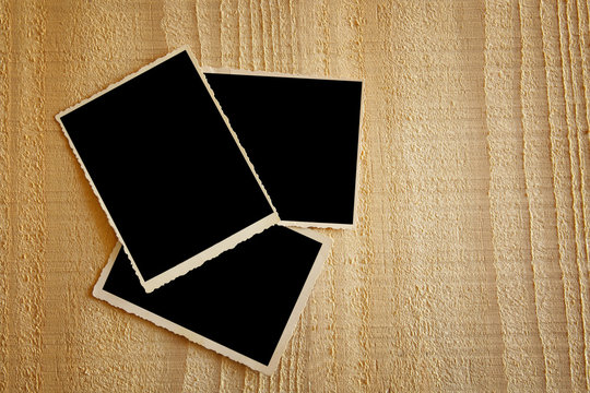 top view of blank photos frame on wooden background