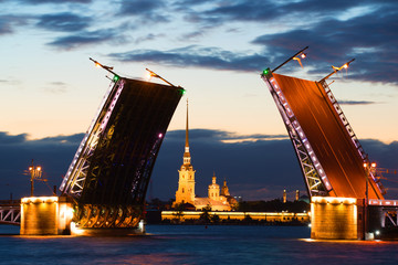 Fototapeta na wymiar Peter and Paul Cathedral in the alignment of the diluted Palace Bridge at white night. Saint-Petersburg, Russia