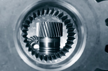 aerospace cogs and gears seen through large gear-axle