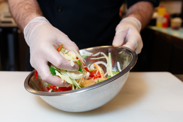 Chef is cooking a vegetarian salad