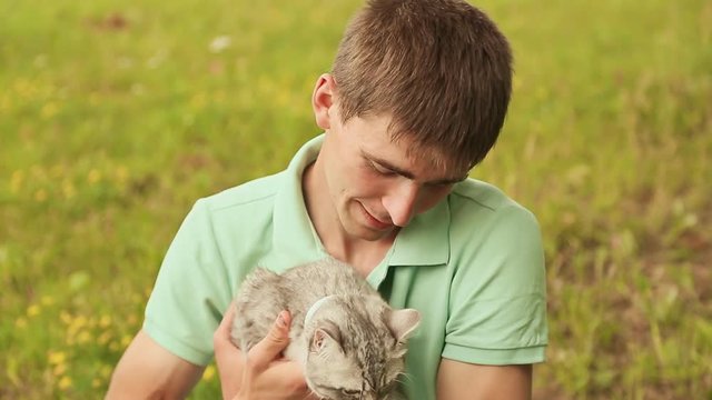Guy holds a gray British cat