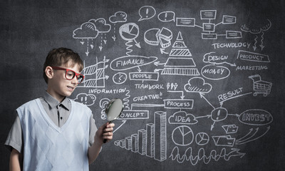 Curious school boy with magnifier