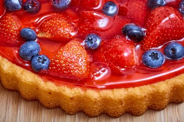 Side view of strawberry and blueberry cake with jelly