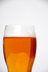 Glass of light beer isolated on a white background