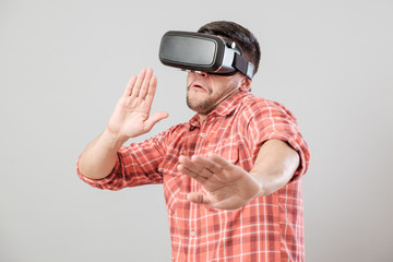 Man with virtual reality glasses showing gesture