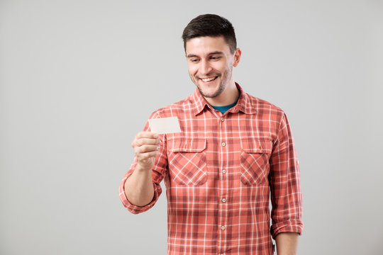 Young Man Reading Business Card