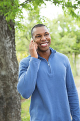 African American man talking and texting mobile phone.