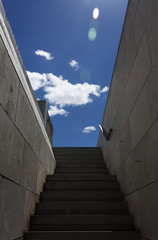 Narrow stairs against blue sky