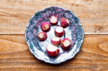 Red radish. Isolated over wooden background