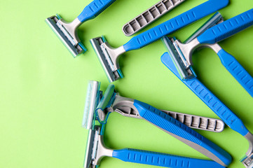 The image of blue razor blades ona a green bakground