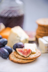 cheese board with grapes,wine,fig and olives