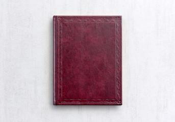 book dark purple color on gray background close-up, top view