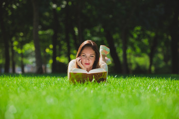 Girl with book on the grass