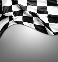 Checkered racing flag on grey background. Copy space