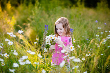 Little girl in daisy flower field