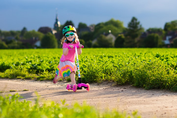 Little girl on a scooter