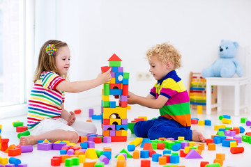 Kids playing with colorful toy blocks