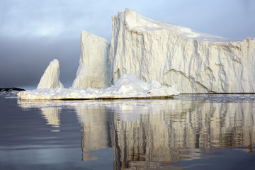 Icebergs are on the arctic ocean on sunset time with shadow