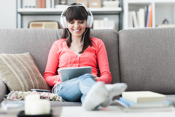 Woman with headphones using a tablet
