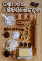 Baking ingredients with wooden pieces and the words MERRY CHRISTMAS burned into them
