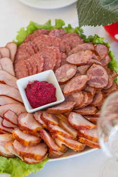 serving assortment slices sausages on plate