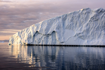 Glaciers are on the arctic ocean in Greenland, there is beautiful iceberg shadow on the sea