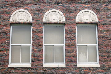 Three Windows in a Red Brick Building