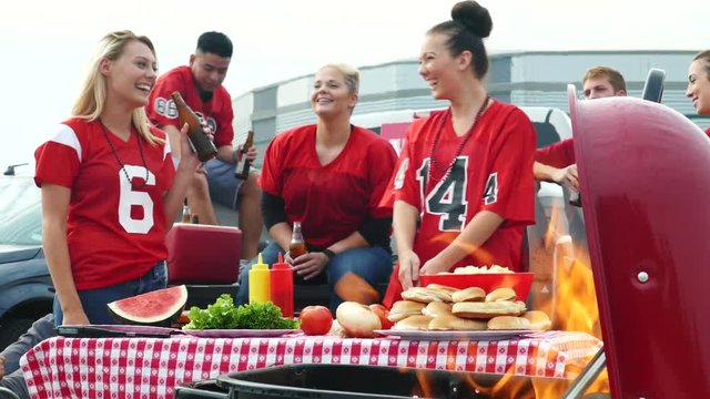 Tailgate: Women Laugh And Have Fun While Preparing Food