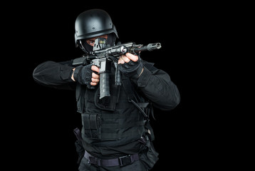 Spec ops police officer SWAT in black uniform and face mask