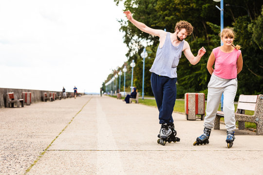 Young people casually rollblading together.
