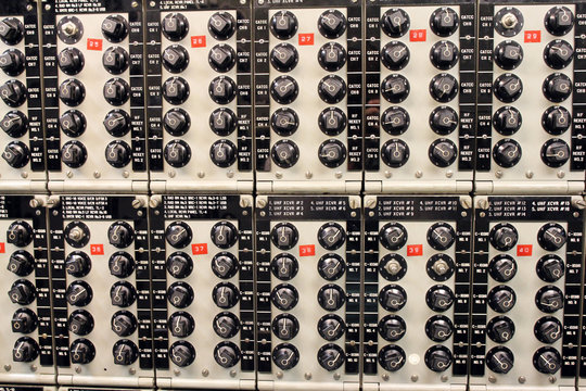 An old electrical panel with receivers and transmitters in the ship radio room, The USS Midway Museum, San Diego, California