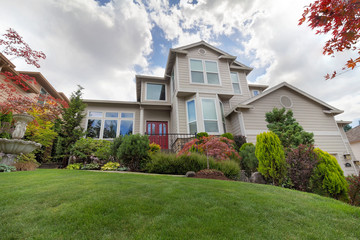 Front Lawn of Traditional Home with manicured garden
