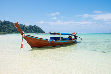 Naklejka na ściany i meble Long tail wooden boat anchor with csytal sea white sand at lipe island,andaman,thailand