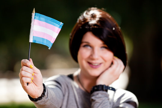 Woman holding transgender flag