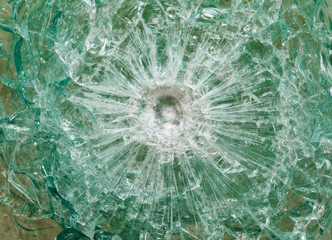 Bulletproof glass after the shooting with traces of bullets, test © hdesert