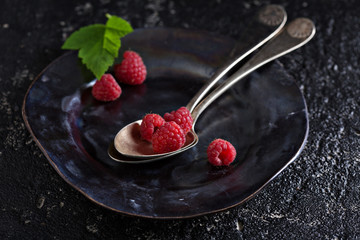 Fresh raspberry in a vintage spoon